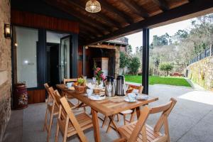 a wooden table and chairs on a patio at Casa do Cesteiro in Santiago de Compostela