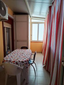 a room with a table and chairs and a window at Trapani love in Trapani