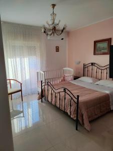 a bedroom with two beds and a chandelier at Trapani love in Trapani