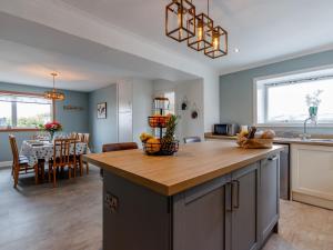 a kitchen and dining room with a kitchen island with a table at 3 Bed in Crieff 78313 in Madderty