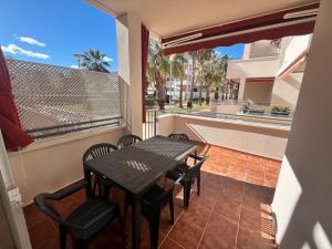 a patio with a table and chairs on a balcony at Apartamentos Arenas Altamar in Alcossebre