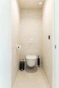 a bathroom with a white toilet in a room at Amarilla Golf Residences in San Miguel de Abona