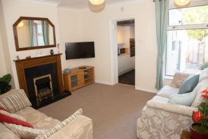 a living room with a couch and a fireplace at Breakfast With A View Free Parking and Water Access in Wallington