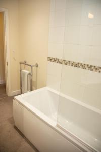 a white bath tub in a bathroom with a shower at Breakfast With A View Free Parking and Water Access in Wallington