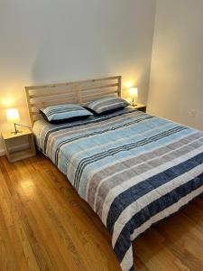a bedroom with a bed with two pillows on it at Bright & Spacious 3-Bed Close to NYC in Jersey City
