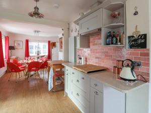 a kitchen and dining room with a brick wall at Wayside in Seaton