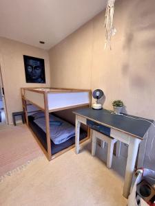 a room with a desk and a bed and a table at Výhledna in Beroun