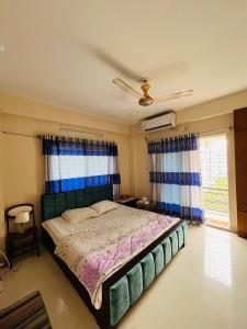 a bedroom with a bed and a ceiling fan at Entire place-4BHK Apartment Bashundhara R/A in Dhaka