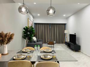 a living room with a dining table and chairs at Eaton Residence KLCC BY Galaxy Suites in Kuala Lumpur