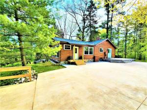 a house with a large driveway in front of it at Creekside Hot Tub-Walk to Beach-Uniquely Northern in Traverse City