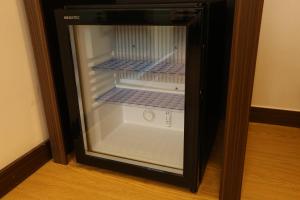 a small refrigerator with its door open in a room at Philstay Dongdaemun Economic in Seoul