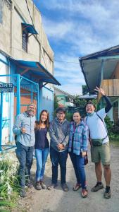 a group of people standing in front of a building at Pintu Biru Hostel in Wamena