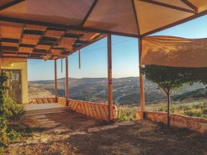 a porch of a house with a view at Breeze House in Kafr Khall