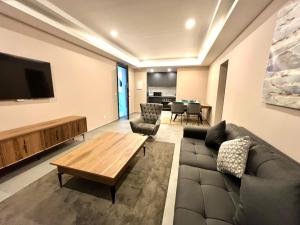 a living room with a couch and a flat screen tv at Kololi Sands Apartments in Sere Kunda