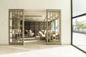 a room with chairs and a table in a building at Amarilla Golf Residences in San Miguel de Abona +158 photos