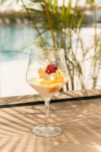a wine glass with fruit in it on a table at Amarilla Golf Residences in San Miguel de Abona