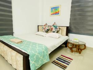 a bedroom with two beds and a table at Penthouse -Private Room with Attach bath Ac & Rooftop in Dhaka