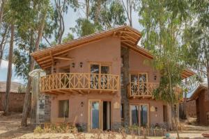 a house under construction with a balcony on it at Cabaña Maras Peru in Maras
