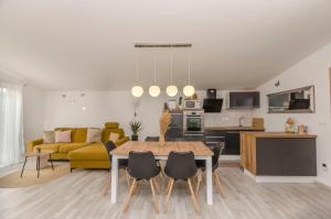 a living room with a table and a yellow couch at Apartment Tarle in Vodice