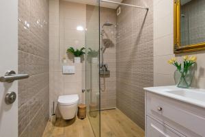 a bathroom with a shower and a toilet and a sink at Apartment APARTMAN MIA in Brodarica +20 photos