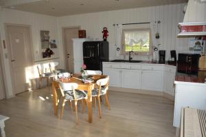 a kitchen with a table and chairs and a dining room at Le Chalet De Papitou in Hockai
