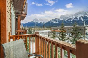 a balcony with a view of snow covered mountains at Stoneridge Mountain Resort Condo hosted by Fenwick Vacation Rentals in Canmore