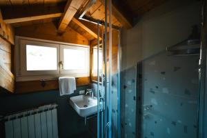 a bathroom with a sink and a shower at Hurban Apartments Muggia in Muggia +32 photos