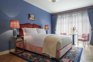 a bedroom with a large bed and a blue wall at Broadwick Soho in London