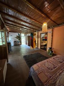 a large room with a bed and a room with a room at Cabaña Canto de las Aguas Cañón del Combeima in Ibagué