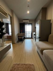 a living room with a couch and a table at The Cozy, 3 min walk to MRT, 2 STN to Royal Palace in Bangkok Yai