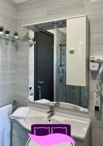 a bathroom with a sink and a large mirror at B&B ANASTASIA in Pompei