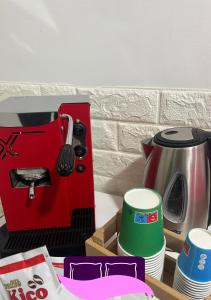 a kitchen counter with a red sewing machine and cups at B&B ANASTASIA in Pompei