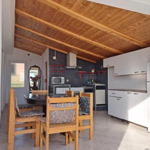 a kitchen and dining room with a wooden ceiling at Guest House Tanja in Orebić