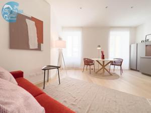 a living room with a red couch and a table at Slataper 12 Tirabora Short Rent in Trieste