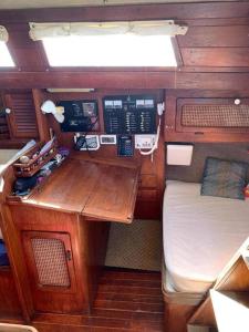 Habitación pequeña con escritorio y cama en un barco en Voilier privatisé au mouillage, en Fort-de-France