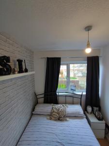 a bedroom with two beds and a large window at Cosy House in Birmingham Excellent connections to city centre in Birmingham