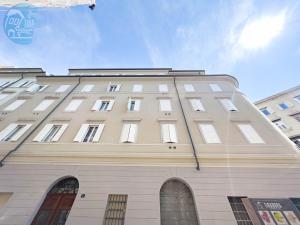 a large white building with many windows on it at Slataper 12 Tirabora Short Rent in Trieste