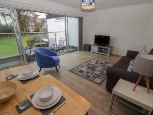 a living room with a couch and a table at 19 Coedrath Park in Saundersfoot