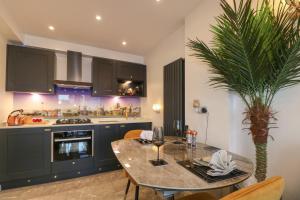 a kitchen with a table with a palm tree in it at Beach Retreat in Seaford