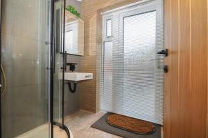 a bathroom with a shower and a sink at Beach Retreat in Seaford
