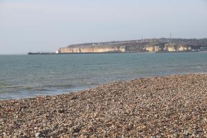 a rocky beach with the ocean in the background at Beach Retreat in Seaford