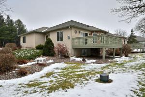 a house with a deck in the snow at Unit 701 5 bd 3 ba condo in Birchwood