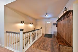 a staircase in a home with white railings and wood floors at Unit 701 5 bd 3 ba condo in Birchwood