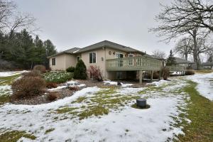 a house with a deck in the snow at Unit 701 5 bd 3 ba condo in Birchwood