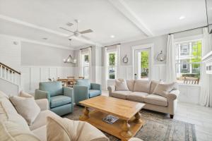 a living room with couches and a table at Do Grayt Things by 30A Escapes in Grayton Beach