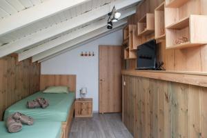 two beds in a room with wooden cabinets at Giannis House in Rhodes Town