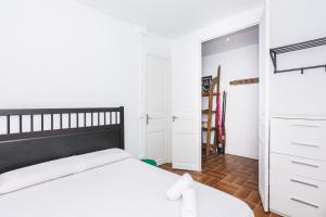 a bedroom with a white bed and a closet at HomeHolidaysRentals Arlene in Calella