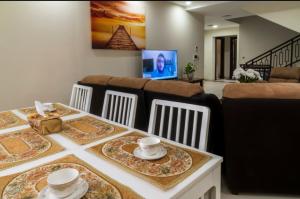 a dining room table with chairs and a couch at Villa in Al Madinah in compound فيلا في المدينة in Al Madinah