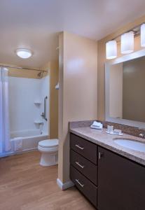 a bathroom with a sink and a toilet and a mirror at TownePlace Suites by Marriott Albuquerque North in Albuquerque