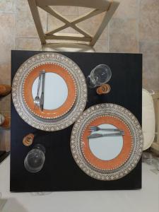 two plates and utensils on top of a table at Nature retreat apartment in Kalafatiónes